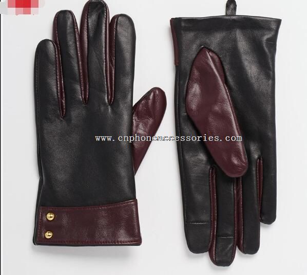 Ladies smart phone wearing leather gloves